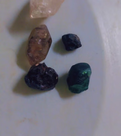 Raw stones between diamond and emerald